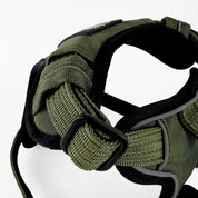 Close-up of a Rogue Royalty support padded dog harness in olive green and black, showing the adjustable webbing, black plastic buckle, and padded interior straps against a white background.